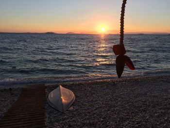 Man on beach against sky during sunset