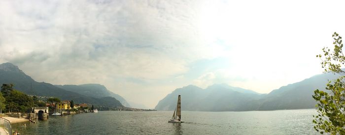 Panoramic view of bay against cloudy sky