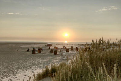 Scenic view of beach against sky during sunset