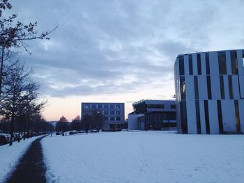 Snow covered city against sky