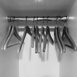 Close-up of coathangers hanging on rod