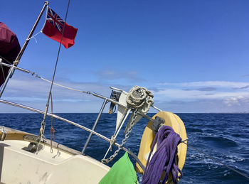 Traditional british boat sailing on sea against sky