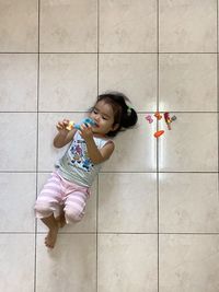 High angle view of woman sitting on floor