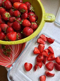 Fresh strawberries, peeling strawberries, washed fruits, slicing strawberries for salad, macedonia 