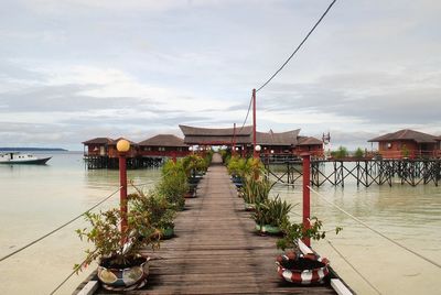 Pier over water against sky