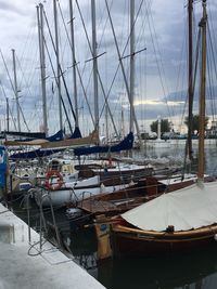 Sailboats moored in sea against sky