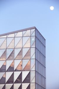 Low angle view of modern building against clear blue sky
