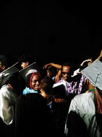 Group of people enjoying music concert at night