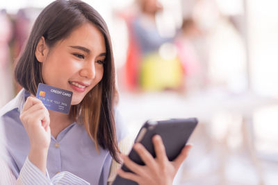 Portrait of a young woman using mobile phone