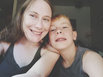 Portrait of smiling mother and son indoor