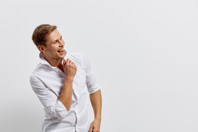 Young woman standing against white background