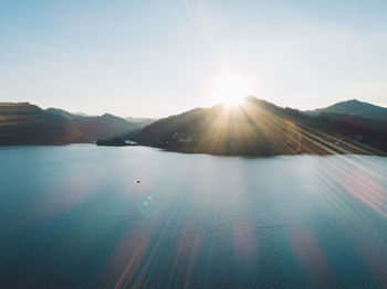 Scenic view of mountains against sky on sunny day