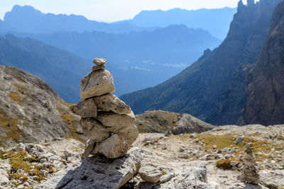 Stack of rocks on mountain against sky