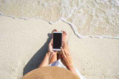 High angle view of man using mobile phone at beach