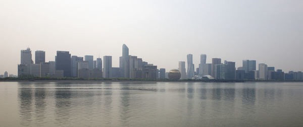 Modern buildings in city against clear sky