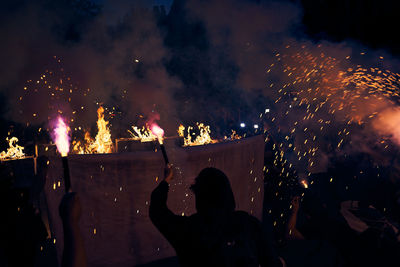 People watching firework display at night