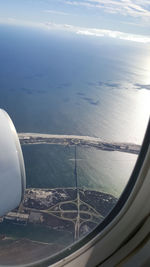 Aerial view of sea and airplane wing