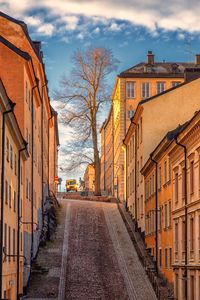 Narrow street amidst buildings against sky