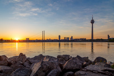 Scenic view of river at sunset