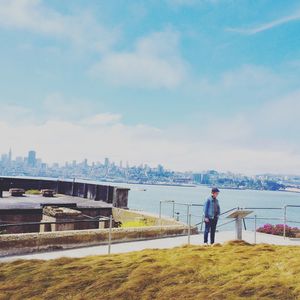 Man standing by sea against sky