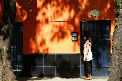 Woman standing by fire hydrant