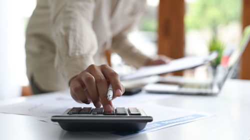 Midsection of woman working on table