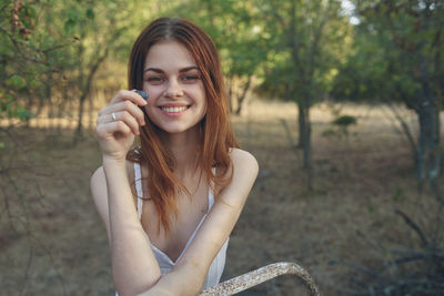 Portrait of smiling woman in forest