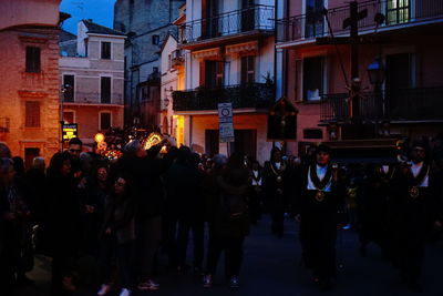 Group of people on street in city at night