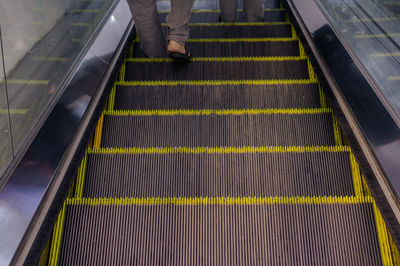 Low section of man standing on steps