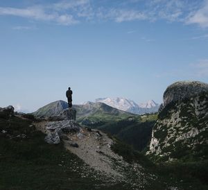 Man standing on rock against alpine glacier marmolada