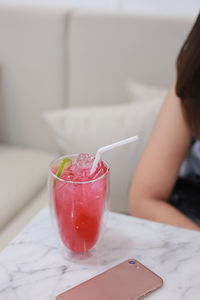 Close-up of woman with drink on table