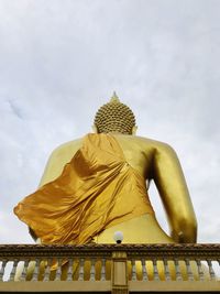 Low angle view of statue against temple against sky