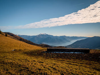 Scenic view of snowcapped mountains against blue sky