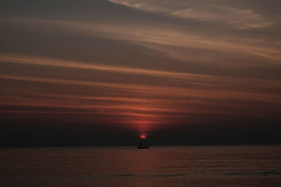 Scenic view of sea against orange sky