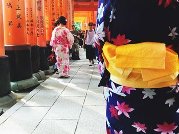 High angle view of people walking on tiled floor