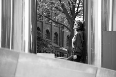 Woman standing by window