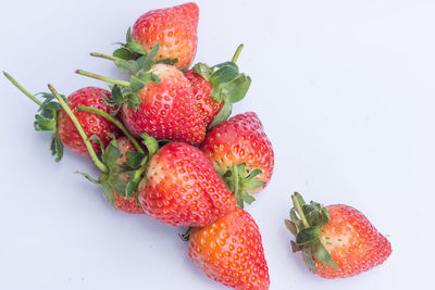 High angle view of strawberries on table against white background
