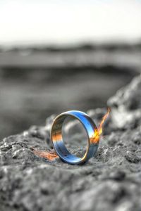 Close-up of wedding rings on sand