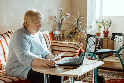 Boy sitting on table at home