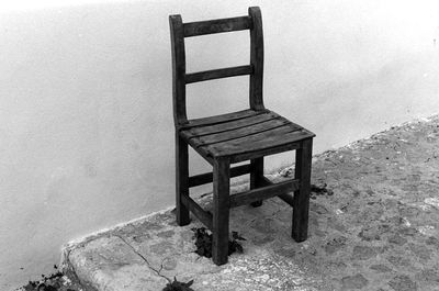 Chair in sea against sky