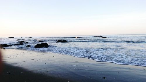 Scenic view of beach against clear sky