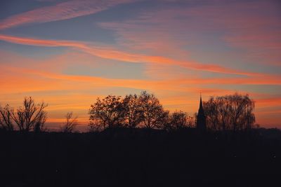 Silhouette trees against sky during sunset