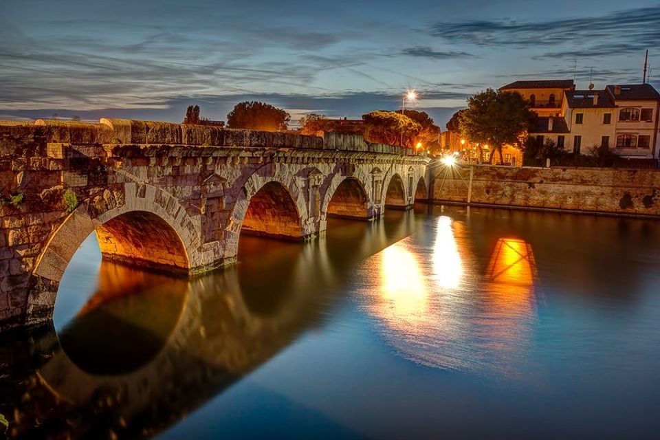 architecture, built structure, water, reflection, building exterior, river, connection, bridge - man made structure, waterfront, sunset, arch bridge, sky, arch, bridge, canal, city, outdoors, tree, no people, transportation