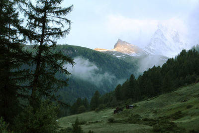 Scenic view of mountains against cloudy sky