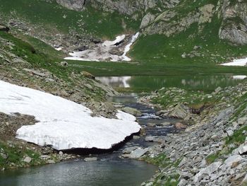 Calm lake along rocky landscape