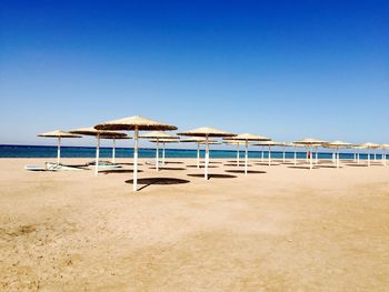 View of beach against clear blue sky