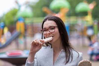 Portrait of young woman eating food