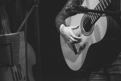 Midsection of guitarist performing on stage