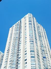 Low angle view of modern building against clear blue sky