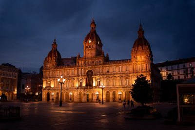 Illuminated building against sky